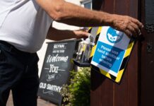 A landlord installs a hand sanitising station outside his pub