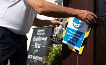 A landlord installs a hand sanitising station outside his pub
