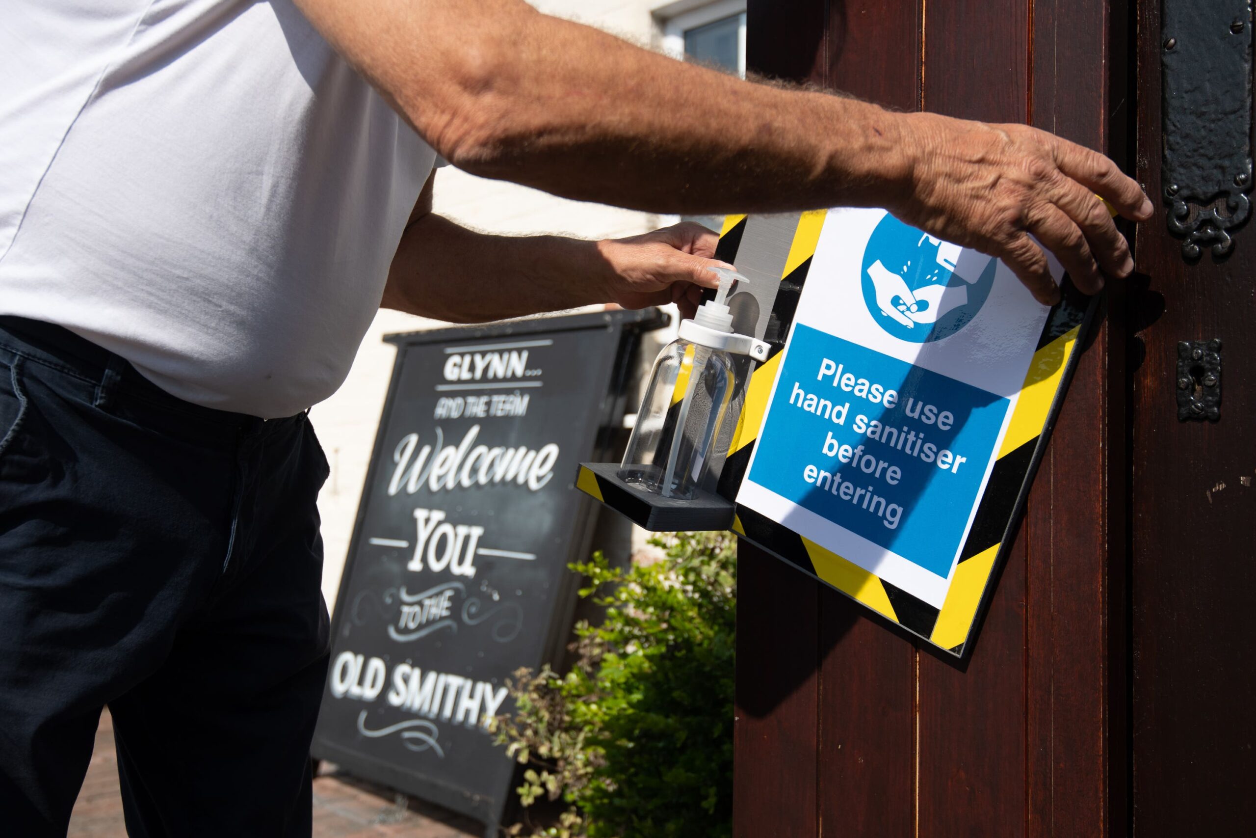 A landlord installs a hand sanitising station outside his pub