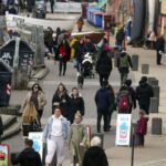 Spring People walk along the seafront in Brighton, East SussexApr 2nd 2021