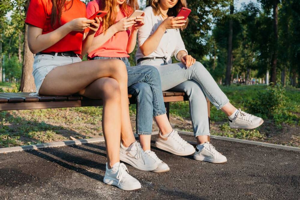diverse three girl friends using their phones outd 2022 04 28 02 47 54 utc