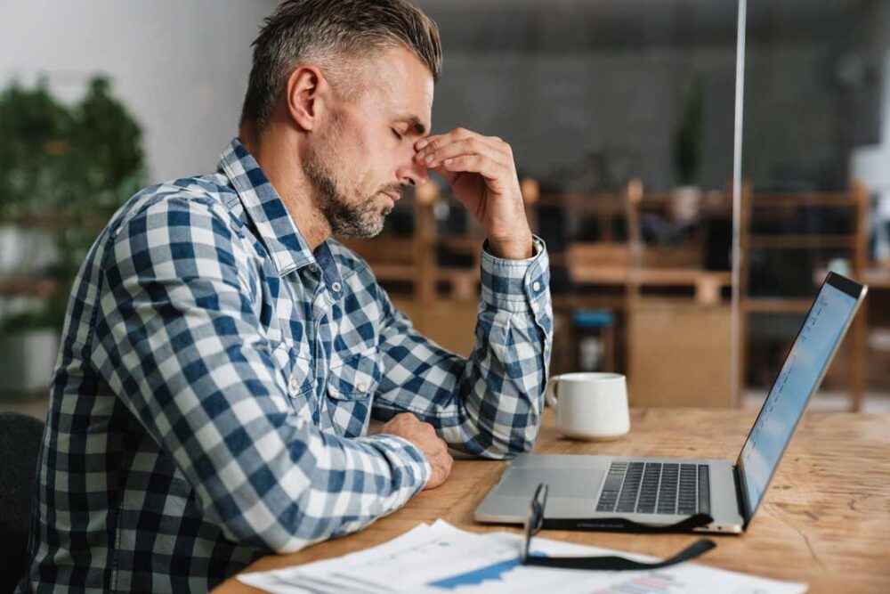 unhappy grey man with headache working with laptop 2021 09 02 08 51 08 utc