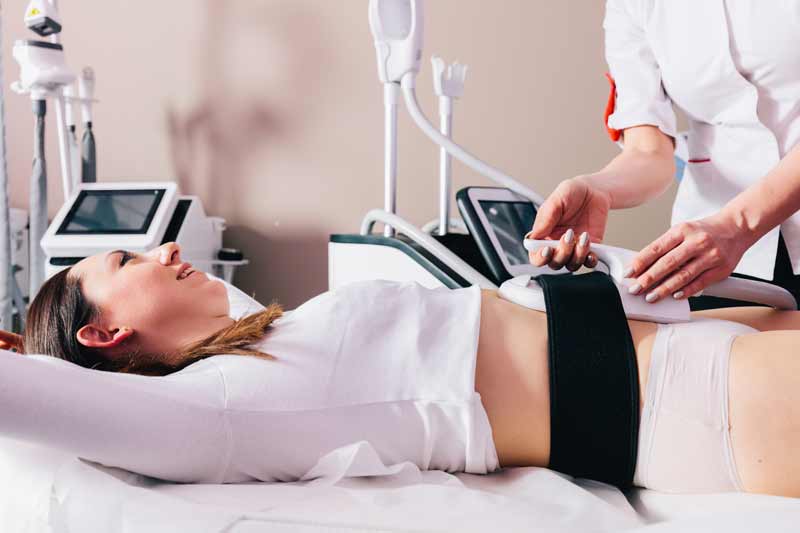 woman getting ems treatment on abdomen to burn fat 2022 12 16 11 07 24 utc