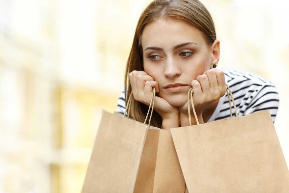 disappointed girl sitting with shopping bags outdo 2023 11 27 05 12 51 utc