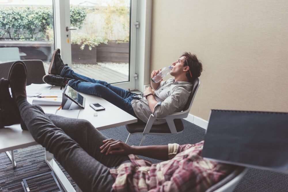 two young students relaxing sitting with legs on t 2023 11 27 05 12 17 utc Large