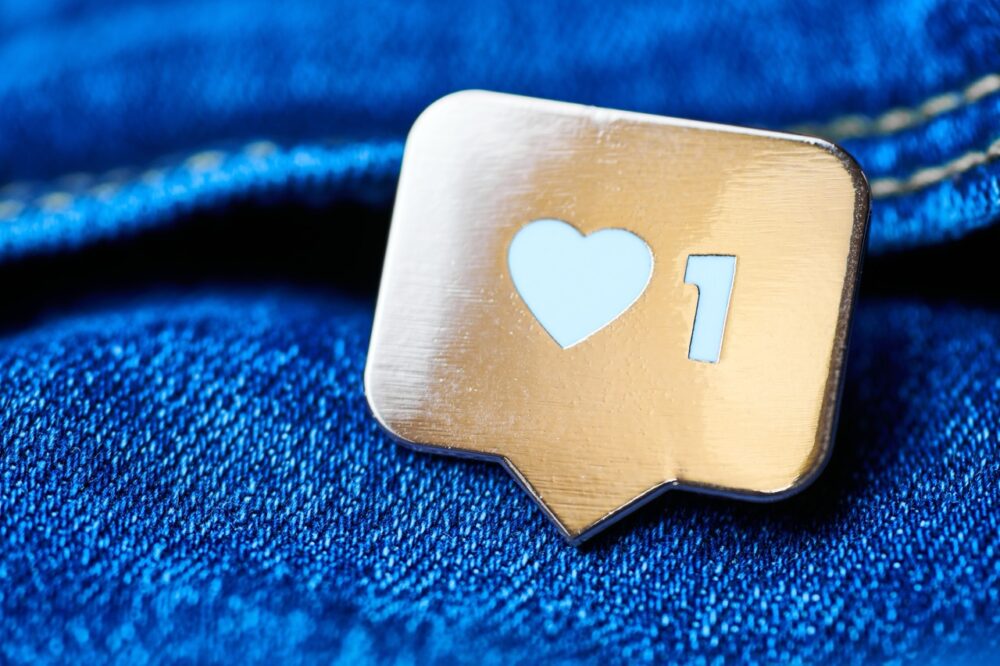 Instagram heart symbol on a pin badge
