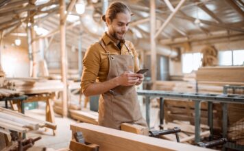 carpenter with phone in the workshop 2023 11 27 05 06 06 utc Large 1