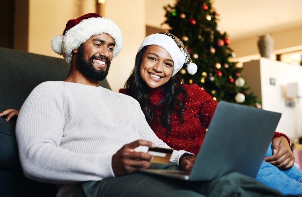 shot of a happy young couple using a laptop and cr 2023 11 27 05 15 10 utc Large