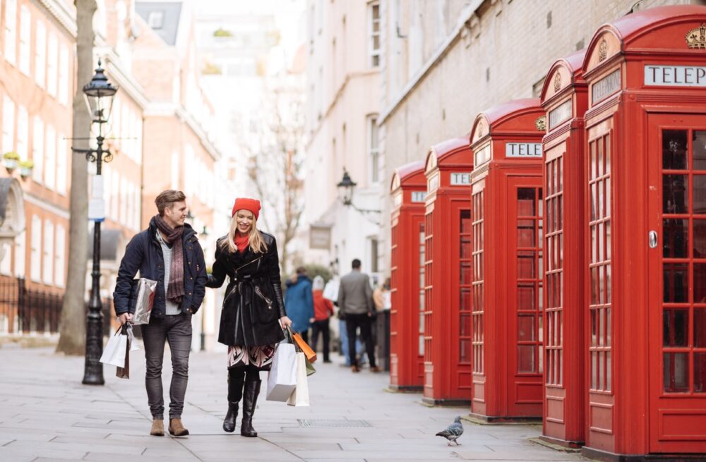 young shopping couple strolling past red phone box 2023 11 27 05 29 20 utc Large