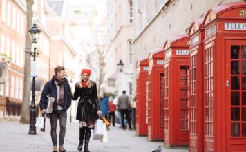 young shopping couple strolling past red phone box 2023 11 27 05 29 20 utc Large