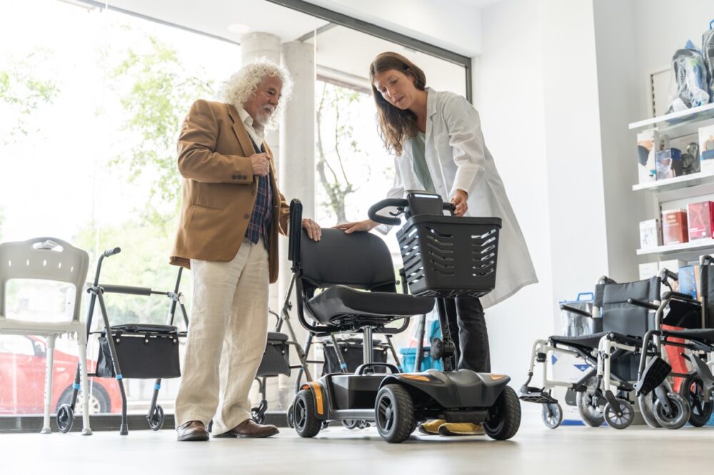 older man in an orthopedic shop trying out an elec 2024 05 13 17 12 40 utc Large