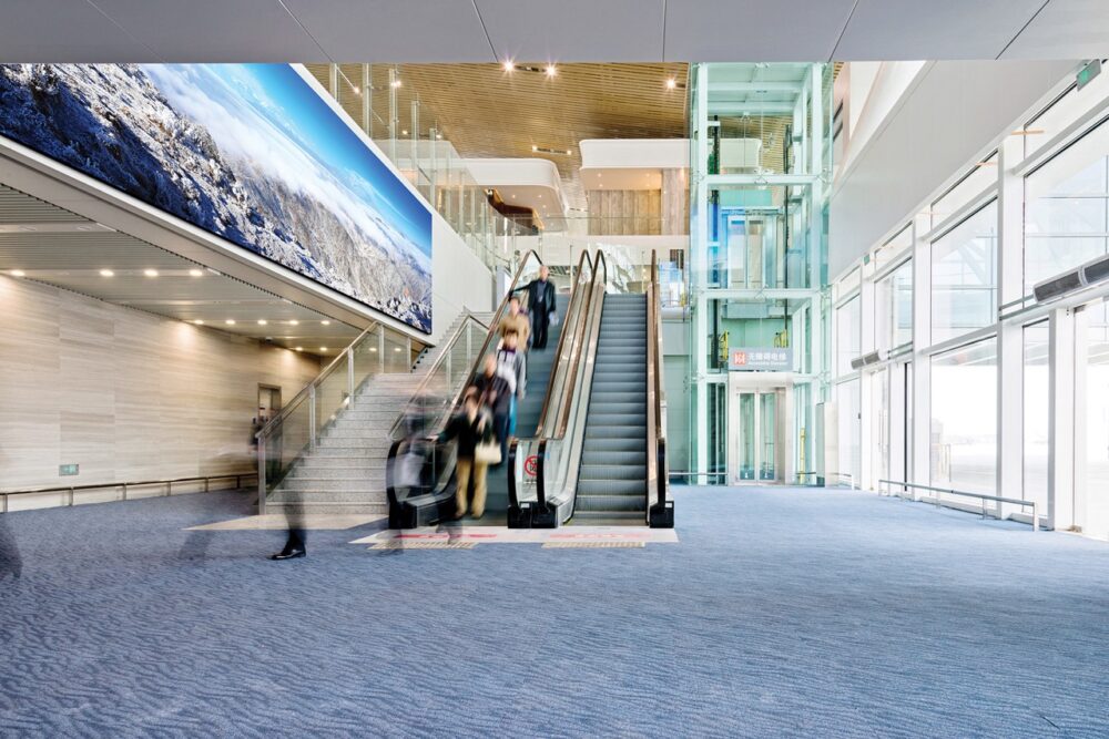 people on an escalator in a building