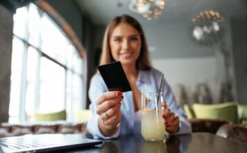 giving the credit card young beautiful woman is i 2026 03 24 05 01 39 utc Large