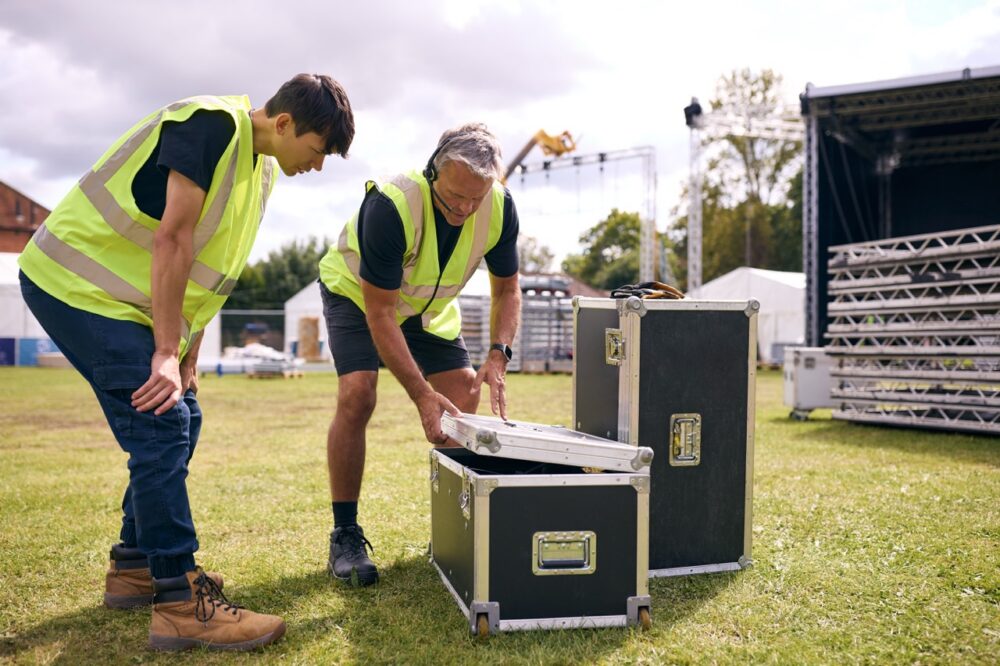 Why Retail Businesses Need A Flight Case For Valuable Equipment 1 men prepare concert equipment on grassy field 2026 01 05 23 02 51 utc Large
