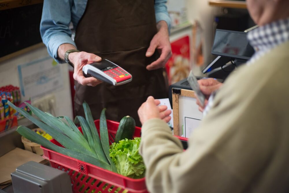 Person paying for groceries at a retail store.
