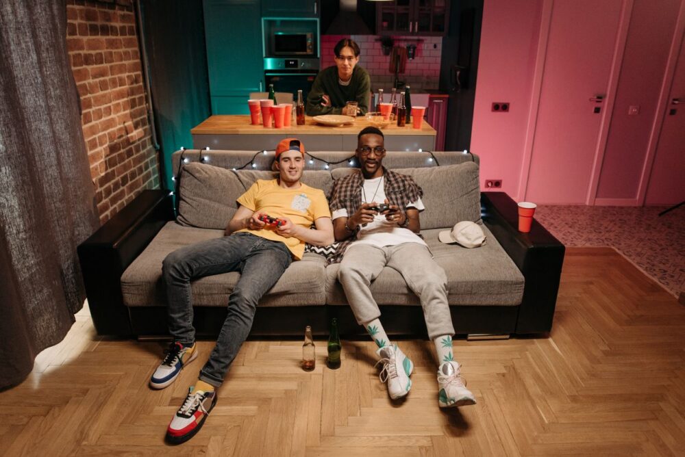 6 Impressive Upgrades For A Grown-Up Games Room 1 Friends playing video games in a room.