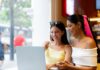 two young women sharing a laptop in a coffee shop 2026 01 08 22 47 43 utc Large