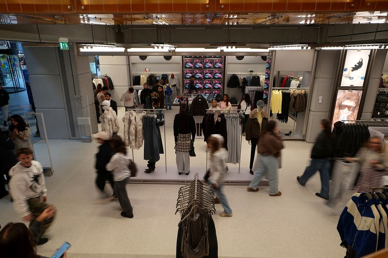 Shoppers browsing rails and mannequins inside Bershka at Westgate Oxford, seen from above