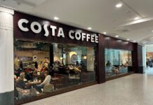 Costa Coffee frontage inside The Liberty shopping centre, with customers seated behind full-height glazing and a Freshly Baked Pastries sign