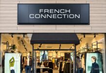 French Connection outlet shopfront at Dalton Park, with black fascia signage, a black awning over the entrance and mannequins in jackets and jeans in the windows