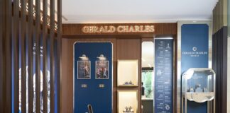 Gerald Charles shop-in-shop at Chung Mei Watch's Nanjing store in Taipei, with walnut slatted screens, blue display panels, a consultation desk and illuminated Gerald Charles lettering