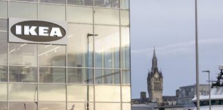 IKEA Opens Plan and Order Point in Aberdeen’s Union Square IKEA sign on the glass corner of a building in Aberdeen, with the harbour, a ship and a clock tower in the background