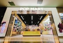 POP MART store entrance with an illuminated archway and character artwork