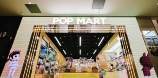 POP MART store entrance with an illuminated archway and character artwork