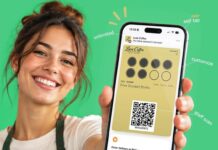 Smiling barista in a green apron holding up a smartphone showing a Luxe Coffee digital stamp card in a mobile wallet, with labels for self tap, staff scan, customisation and optional buttons
