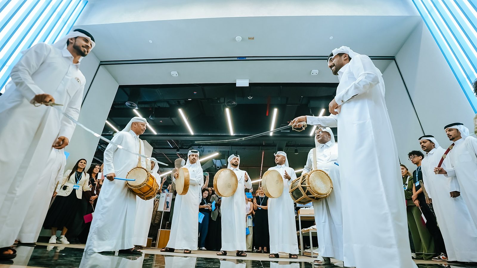 Performers in traditional dress with drums and swords at the store entrance on opening day