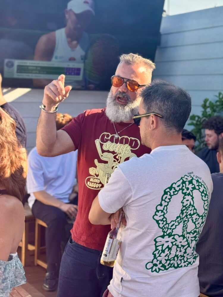 Two guests in conversation on the rooftop at the SDEA Summer Social, July 2026