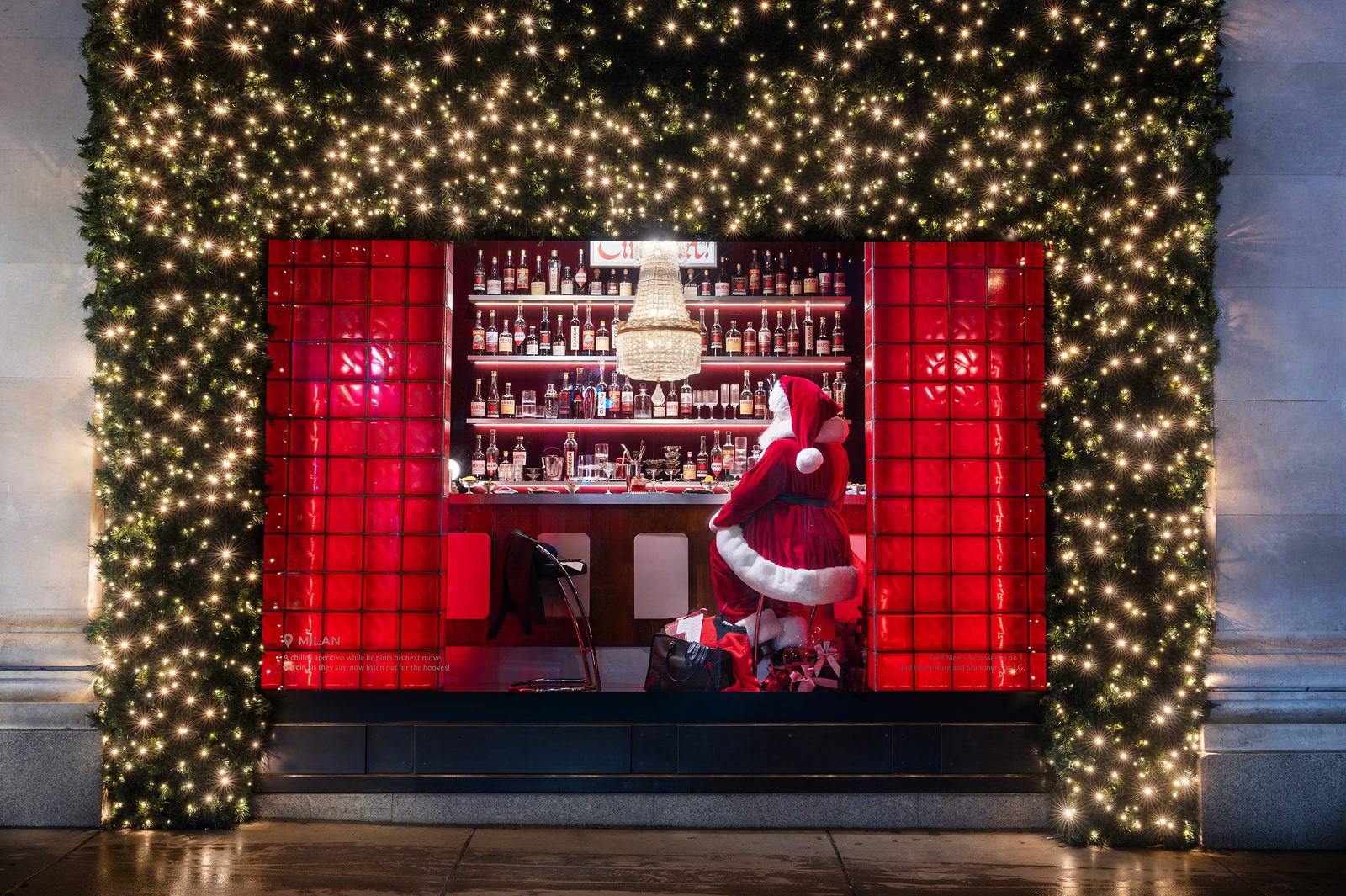 Selfridges' Milan Christmas window, with Santa at a red-tiled aperitivo bar lined with bottles
