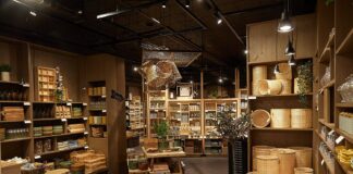 Søstrene Grene store interior with rattan baskets, ceramics and glassware on wooden shelves and display tables
