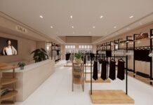Visualisation of the TALA pop-up at Bicester Village, with clothing rails, wooden shelving, a cash desk and a screen showing a TALA campaign image