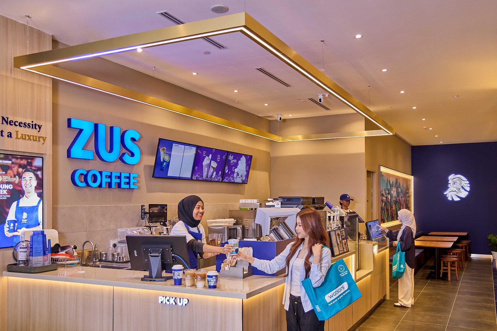 ZUS Coffee counter inside Watsons Plus, with a barista handing a drink to a customer carrying a Watsons bag
